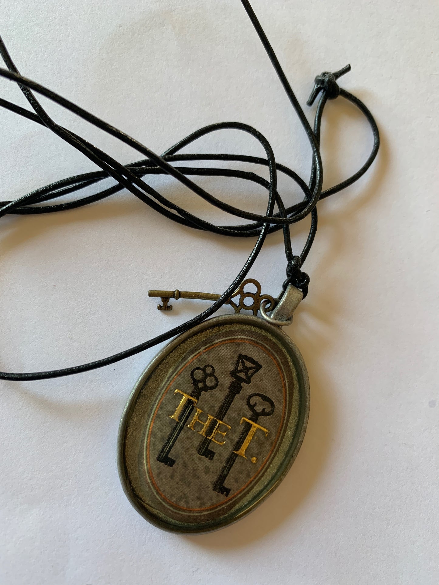 Cigar band charm on black leather