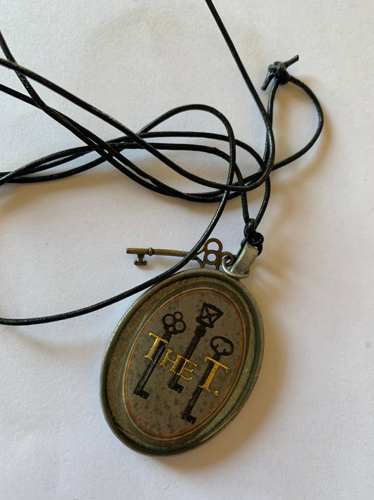 Cigar band charm on black leather