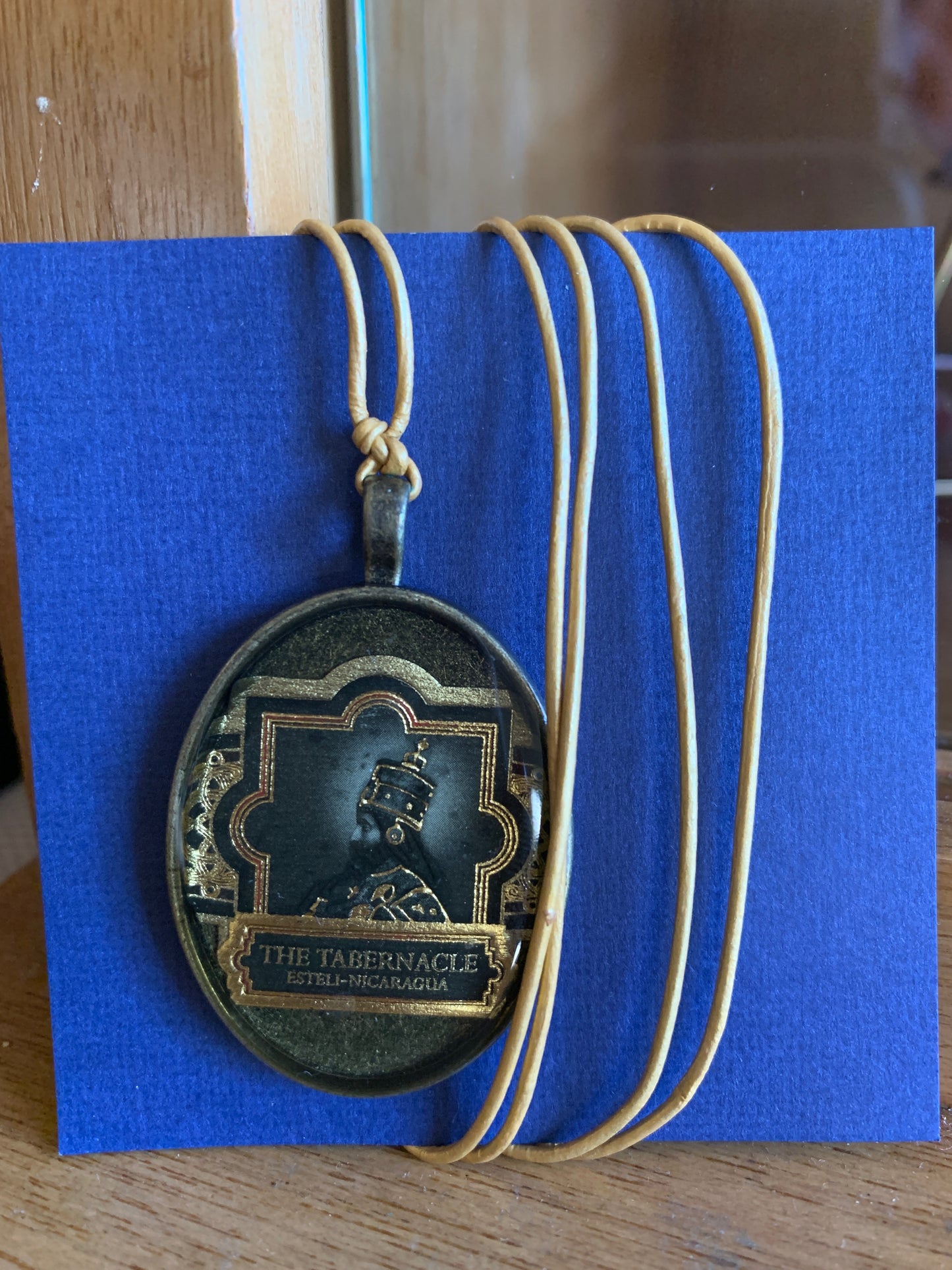 Cigar band charm on golden leather necklace
