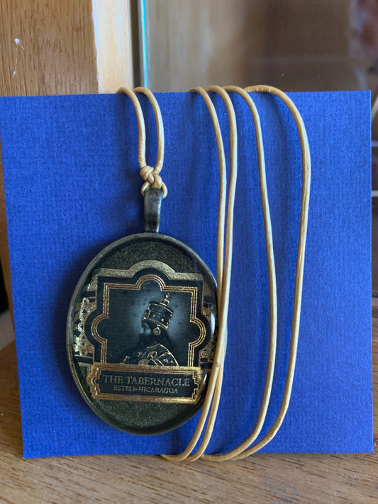 Cigar band charm on golden leather necklace